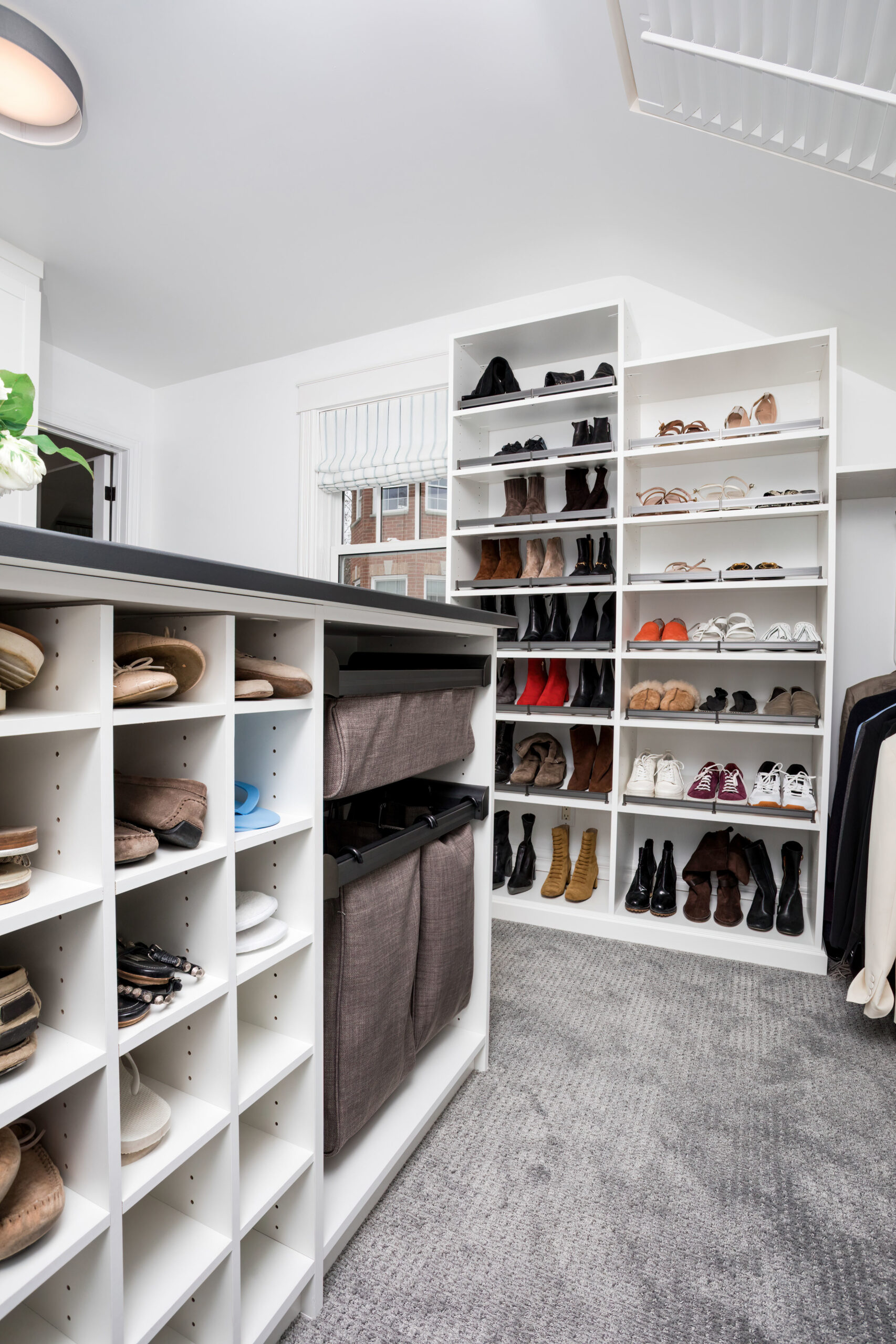 organized closet with folded clothing, shoes, and storage bins