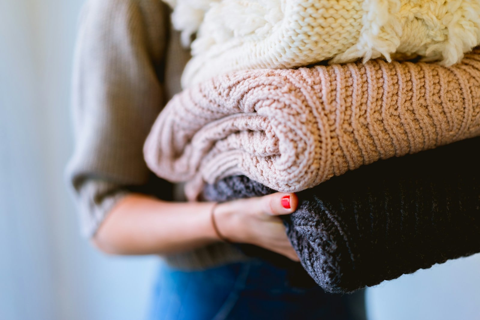 person holding knitted textiles from our featured article