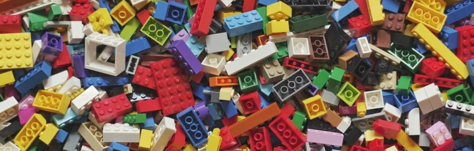 yellow red blue and green lego blocks - a great creative toy painful to step on if homes are not in place