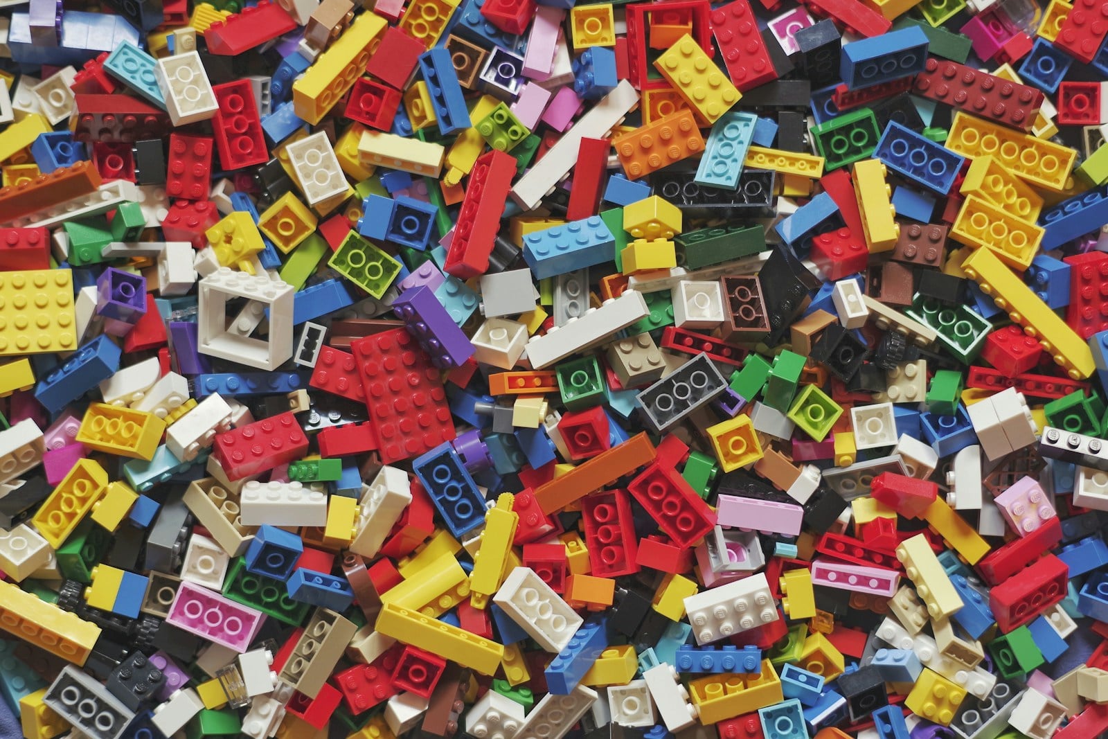yellow red blue and green lego blocks - a great creative toy painful to step on if homes are not in place