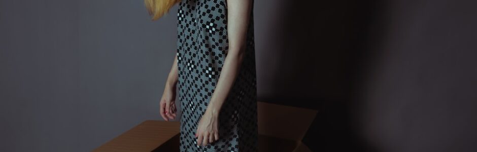 girl in box, tired from decluttering and decision fatigue